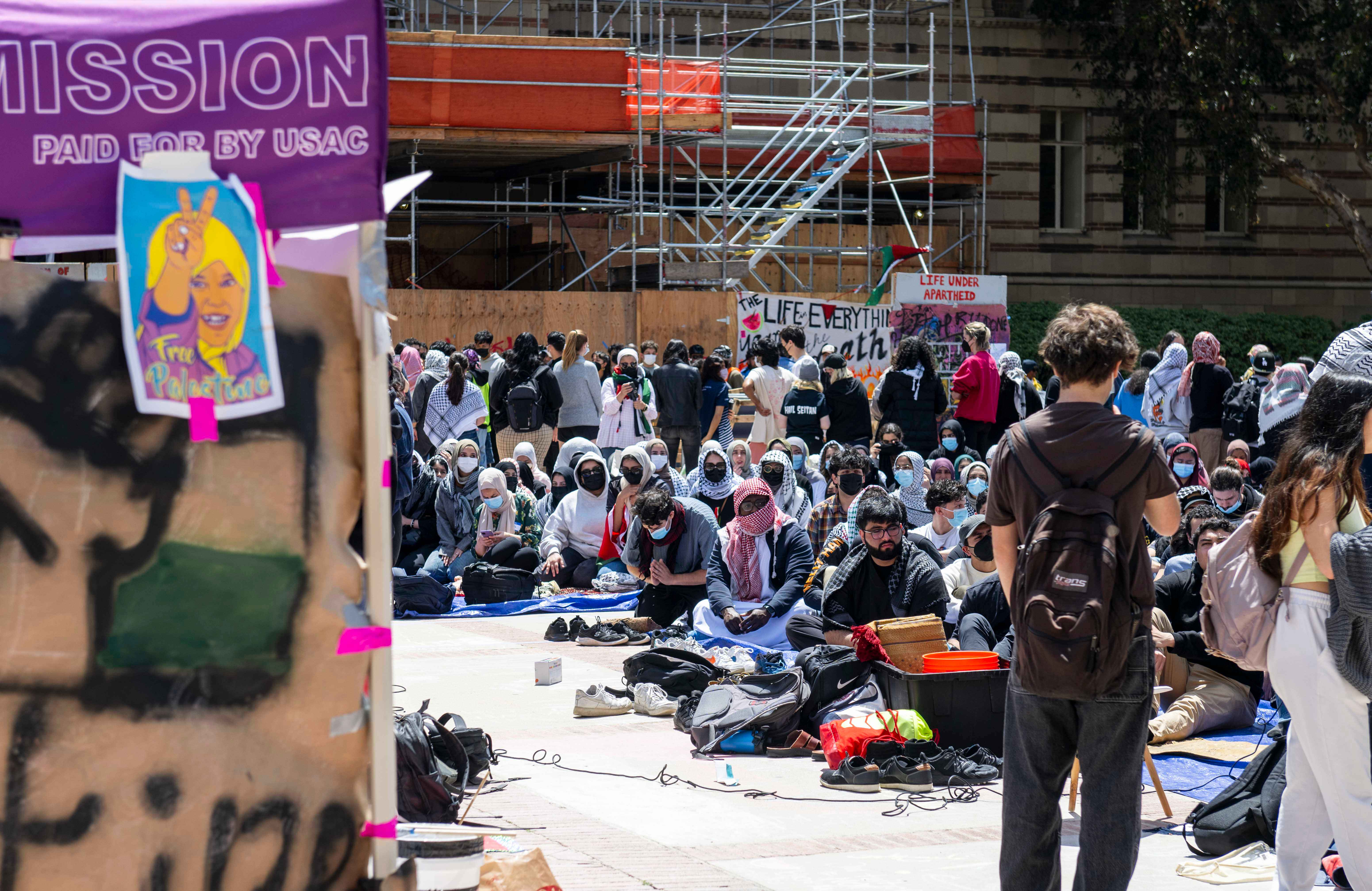 CAC tent with visible USAC endorsement and 'occupation-death' sign